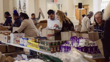 People pack groceries in St. Paul's Chapel