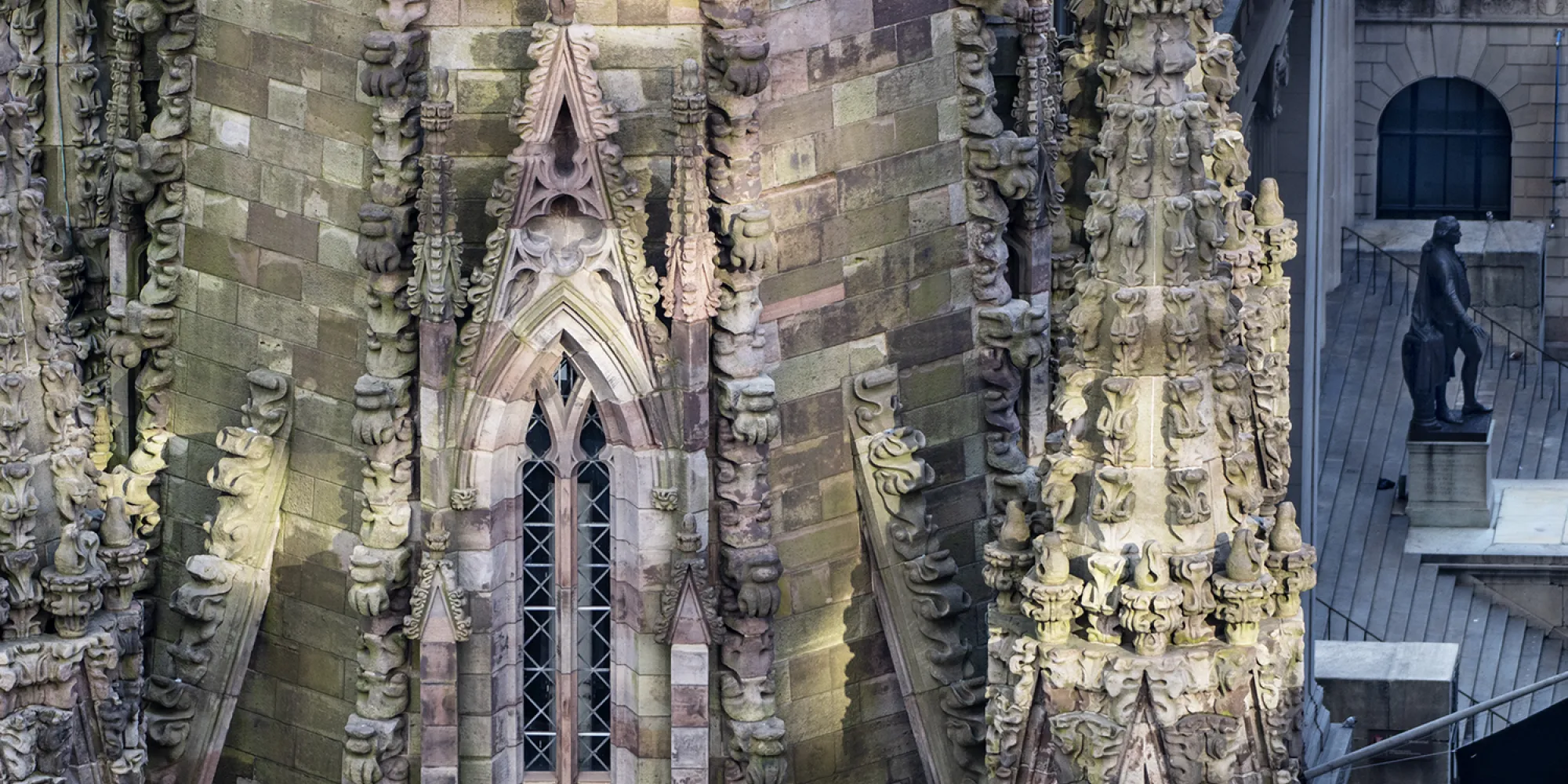 Trinity Church steeple in shadows with Federal Hall behind