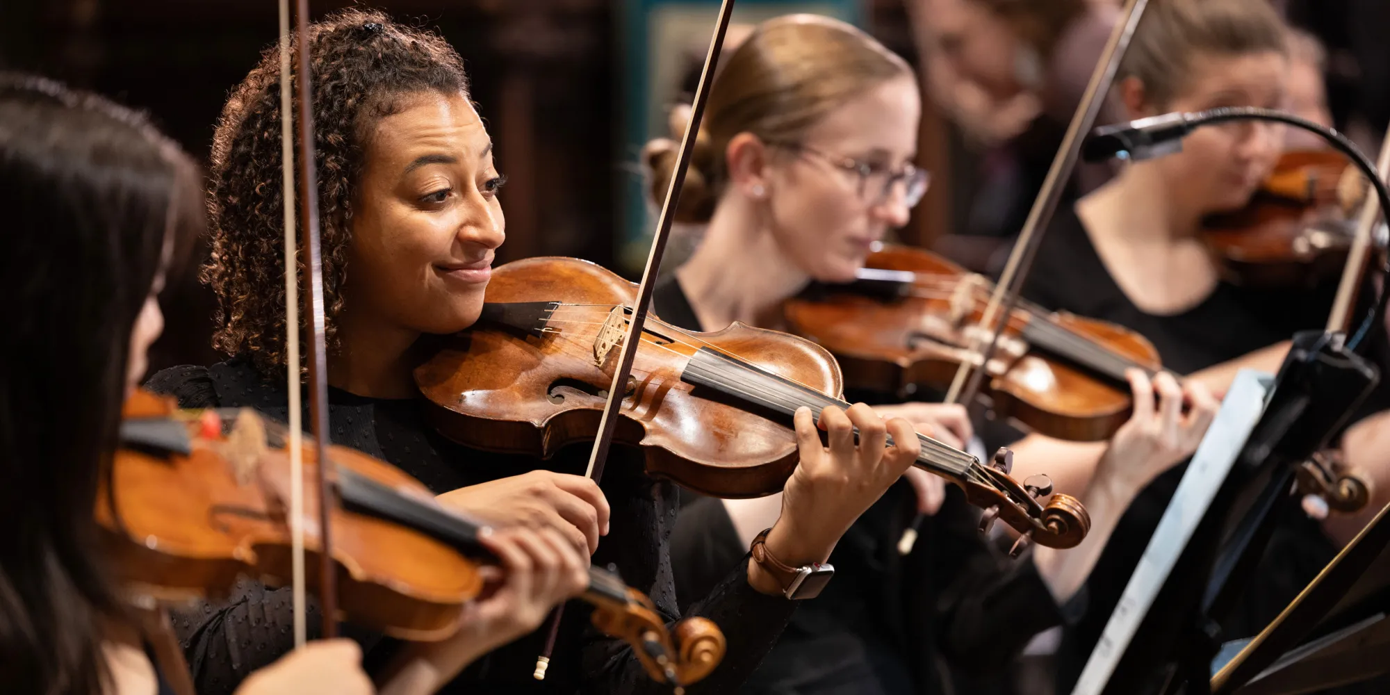 Close-up of violinists from Trinity Baroque Orchestra