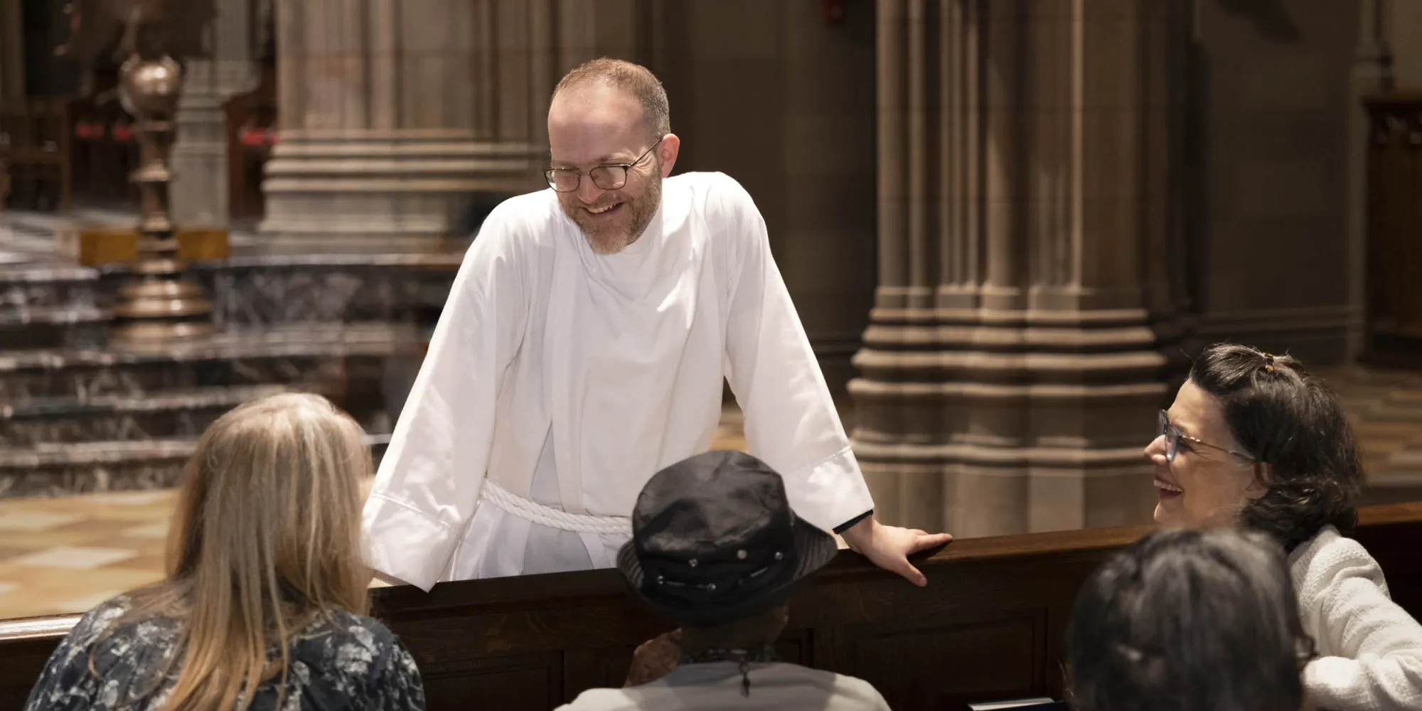 Sacristan talking to people in the church
