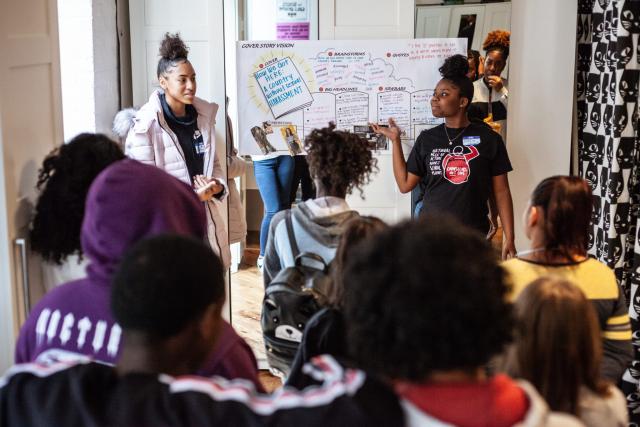 Black girls and LBGTQ+ youth gather in a meeting to discuss a campaign.