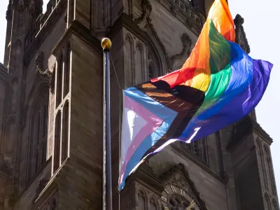 The pride flag with the church in the background