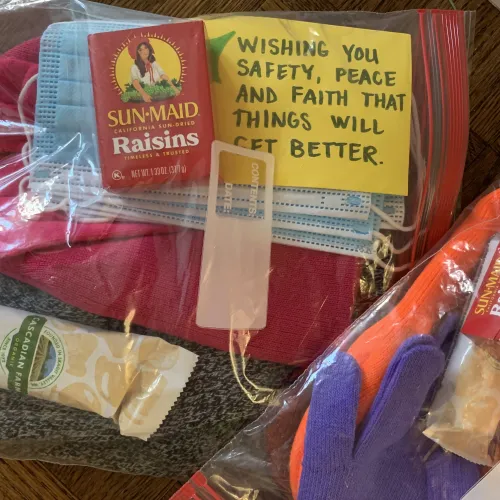 Plastic bags with small non perishable food and care items like masks